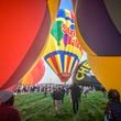 Spectators watch as hot air balloons take off during the mass ascension at the 52nd Albuquerque International Balloon Fiesta in Albuquerque, N.M., on Saturday, Oct. 5, 2024. (AP Photo/Roberto E. Rosales)