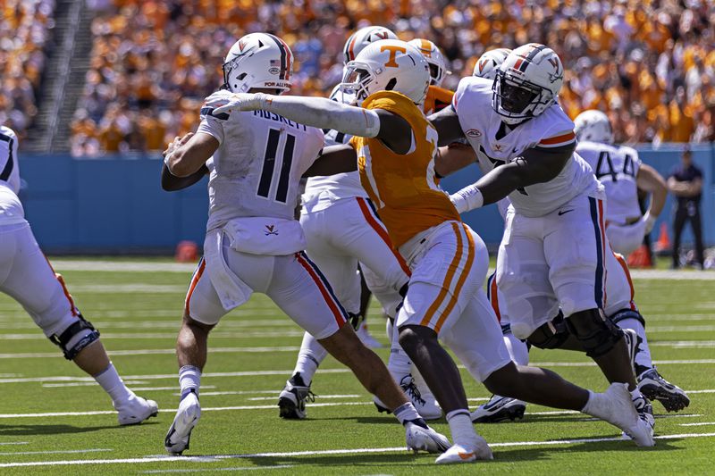 FILE - Virginia quarterback Tony Muskett (11) is pressured by Tennessee defensive lineman James Pearce Jr. (27) during an NCAA football game on Saturday, Sept. 2, 2023, in Nashville, Tenn. (AP Photo/Wade Payne, File)