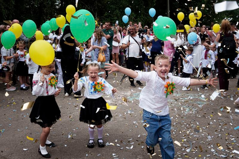 First-grades attend the traditional ceremony for the first day of school in Zaporizhzhia, Ukraine, Sunday Sept. 1, 2024. Zaporizhzhia schoolchildren celebrated the traditional first day of school near the frontline. With the front just 40 kilometers away, the war is never far from the minds of teachers and families. (AP Photo/Evgeniy Maloletka)