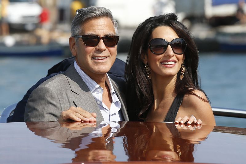 FILE - George Clooney, left, and Amal Alamuddin arrive in Venice, Italy, on Sept. 26, 2014, for their upcoming wedding. (AP Photo/Luca Bruno, File)