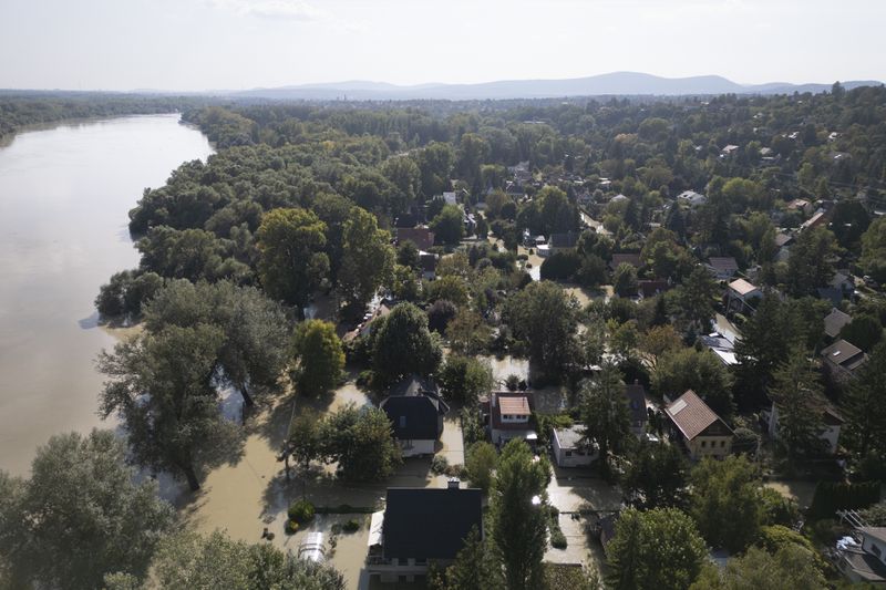 An aerial view of Danube River and a flooded neighbourhood in Szentendre, Hungary, Thursday, Sept. 19, 2024. (AP Photo/Darko Bandic)