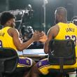 Los Angeles Lakers' LeBron James, right, and his son, Bronny James Jr, shake hands after an interview during the NBA basketball team's media day in El Segundo, Calif., Monday, Sept. 30, 2024. (AP Photo/Jae C. Hong)