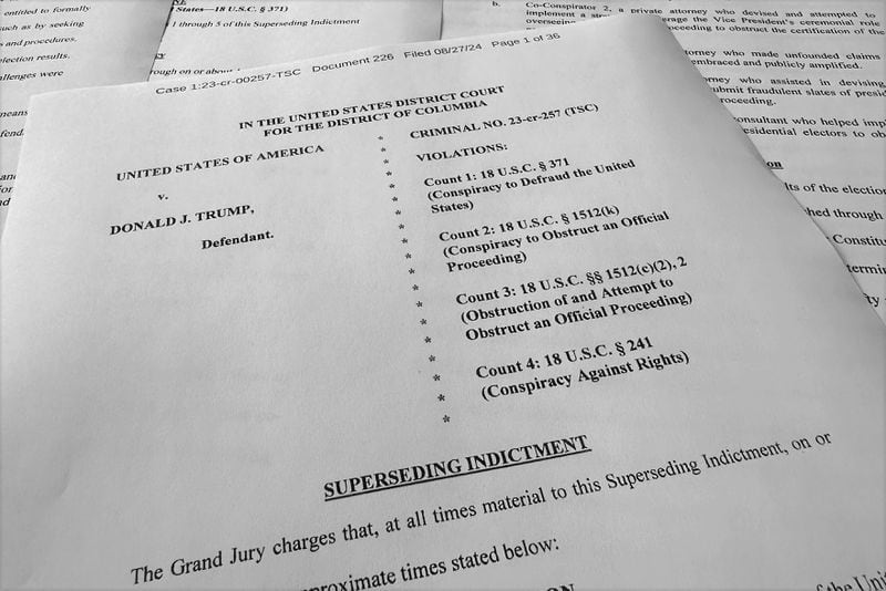 The superseding indictment against former President Donald Trump is photographed Tuesday, Aug. 27, 2024, after special counsel Jack Smith filed the new indictment against Trump that keeps the same criminal charges but narrows the allegations against him following a Supreme Court opinion conferring broad immunity on former presidents. (AP Photo/Jon Elswick)