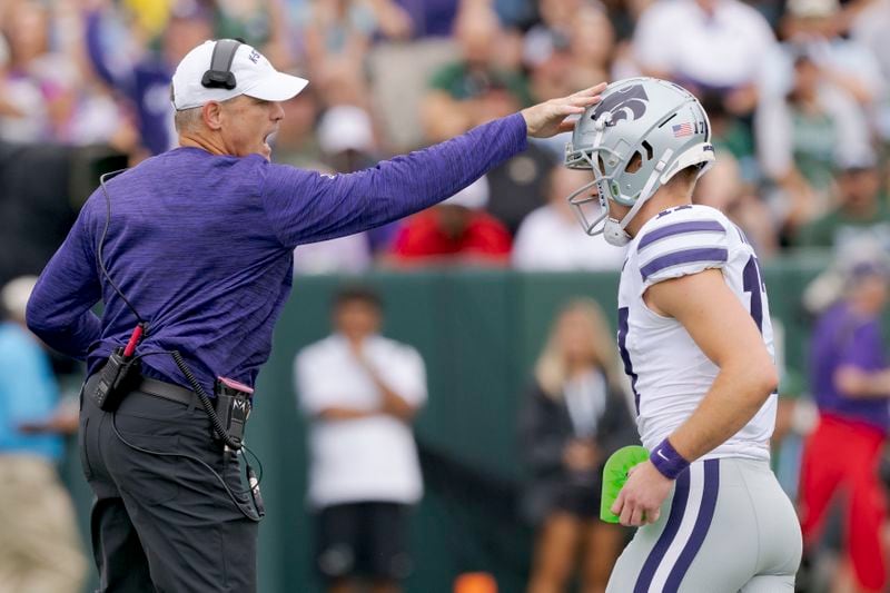 Kansas State head coach Chris Klieman celebrates a kick by Kansas State kicker Chris Tennant (17) during the first half of an NCAA college football game against Tuland in New Orleans, Saturday, Sept. 7, 2024. (AP Photo/Matthew Hinton)