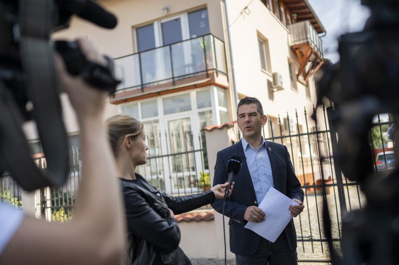 Előd Novak, a member of the National Assembly of Hungary, talks to the local media in front of a house where a Hungarian company that allegedly manufactured pagers that exploded in Lebanon and Syria, is headquartered in Budapest Wednesday, Sept. 18, 2024. (AP Photo/Denes Erdos)