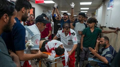 Palestinians wounded in the Israeli bombardment of the Gaza Strip are brought to Al Aqsa hospital in Deir al Balah, Gaza Strip, Tuesday, Thursday, May 23, 2024. (AP Photo/Abdel Kareem Hana)