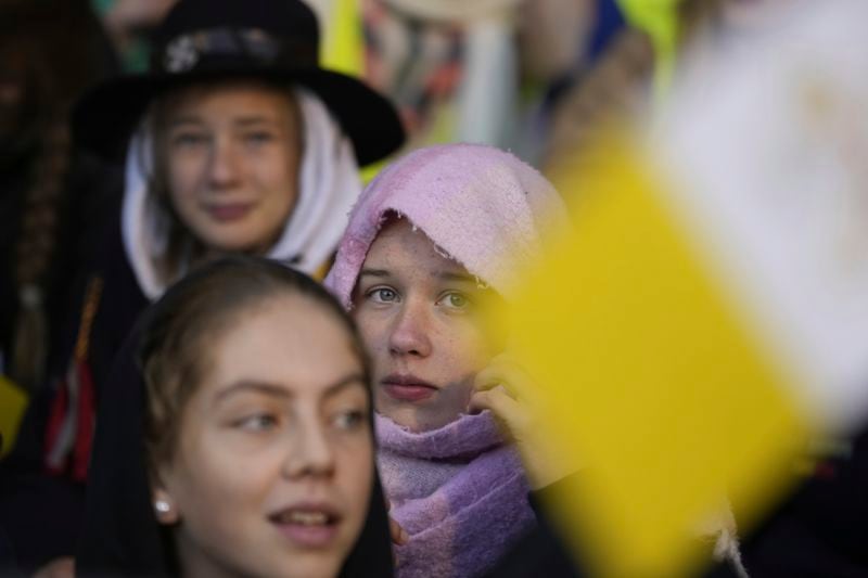 Faithful wait for the start of a mass presided by Pope Francis at King Baudouin Stadium, in Brussels Sunday, Sept. 29, 2024. (AP Photo/Andrew Medichini)