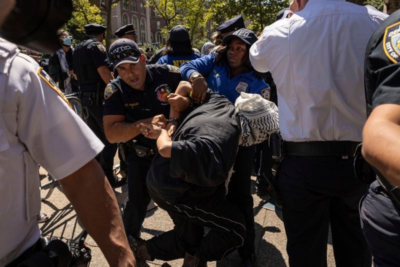 NYPD officers detain a pro-Palestinian supporter as they hold picket line outside Barnard College, Tuesday, Sept. 3, 2024, in New York. (AP Photo/Yuki Iwamura)