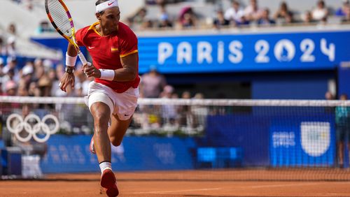 Rafael Nadal of Spain runs for a ball during his match against Marton Fucsovics of Hungary during the men's singles tennis competition, at the 2024 Summer Olympics, Sunday, July 28, 2024, in Paris, France. (AP Photo/Manu Fernandez)