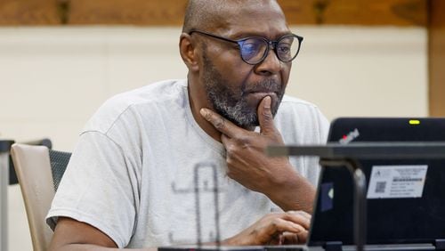 James Mullins, 62, focuses on his laptop during a class at the APS Adult Education Center in southeast Atlanta on Wednesday, Feb. 28, 2024. (Miguel Martinez / miguel.martinezjimenez@ajc.com)