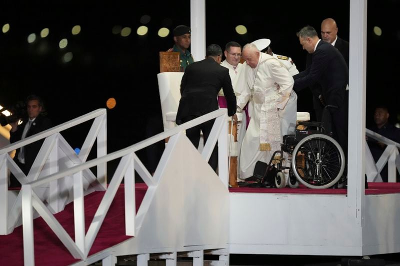 Pope Francis is helped down a ramp at Jackson's International Airport in Port Moresby, Papua New Guinea, Friday, Sept. 6, 2024. (AP Photo/Mark Baker)