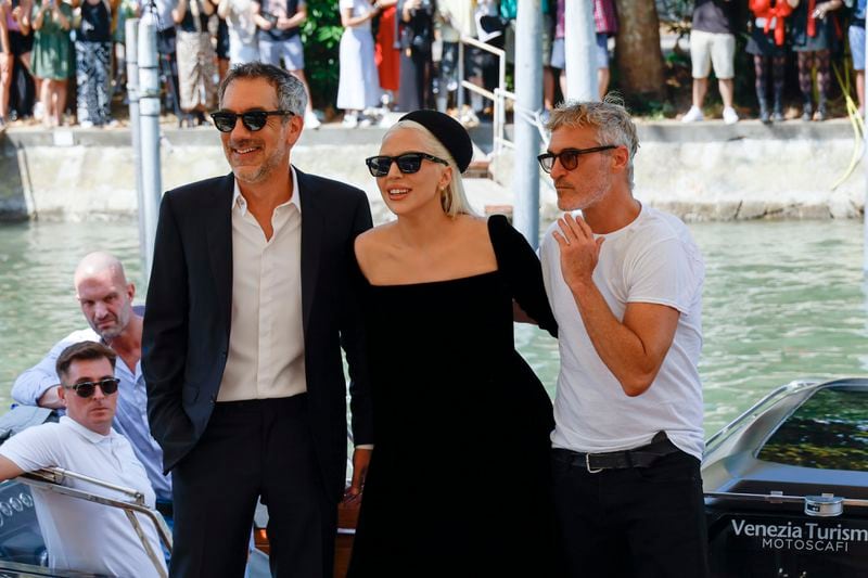 Director Todd Phillips, from left, Lady Gaga and Joaquin Phoenix pose for photographers upon arrival for the press conference of the film 'Joker: Folie A Deux' during the 81st edition of the Venice Film Festival in Venice, Italy, on Wednesday, Sept. 4, 2024. (Photo by Joel C Ryan/Invision/AP)