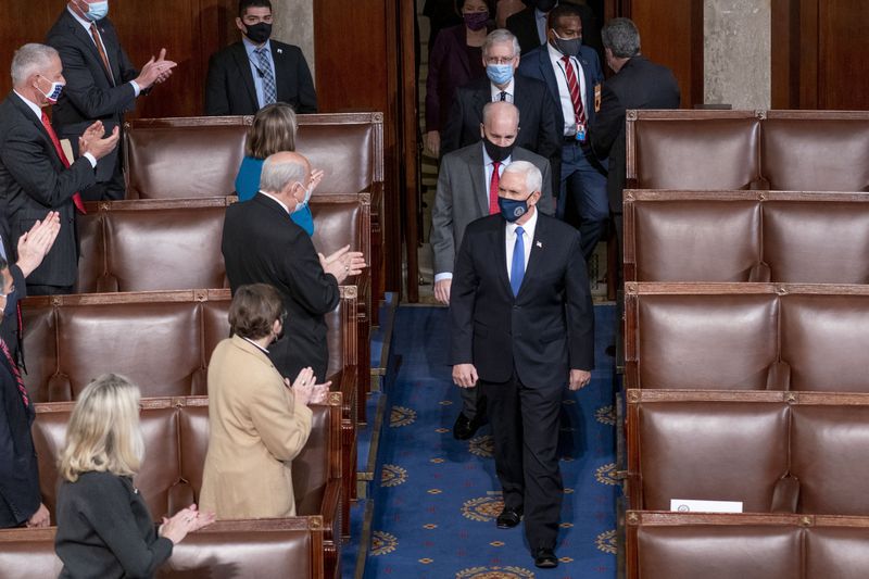 FILE - Vice President Mike Pence and Senate Majority Leader Mitch McConnell of Ky., top center, arrive along with other senators for a joint session of the House and Senate convenes to confirm the electoral votes cast in November's election, at the Capitol in Washington, Jan. 6, 2021. (AP Photo/Andrew Harnik, File)