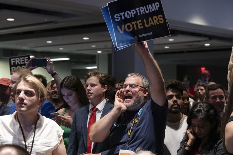 Libertarian delegates jeer Republican presidential candidate and former President Donald Trump as he speaks at the Libertarian National Convention at the Washington Hilton in Washington, Saturday, May 25, 2024. (AP Photo/Jose Luis Magana)