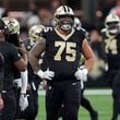 New Orleans Saints offensive tackle Taliese Fuaga (75) looks up at the scoreboard after the Philadelphia Eagles stopped the Saints' final drive with an interception in the fourth quarter of an NFL football game in New Orleans, Sunday, Sept. 22, 2024. (AP Photo/Gerald Herbert)