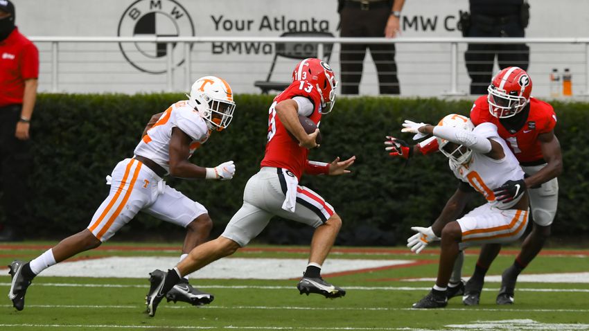 Georgia quarterback Stetson Bennett (13) runs for a td as Tennessee defensive back Jaylen McCollough, left, chases and Tennessee defensive back Bryce Thompson (0) is blocked by Georgia wide receiver George Pickens, right, during the first half of a football game Saturday, Oct. 10, 2020, at Sanford Stadium in Athens. JOHN AMIS FOR THE ATLANTA JOURNAL- CONSTITUTION