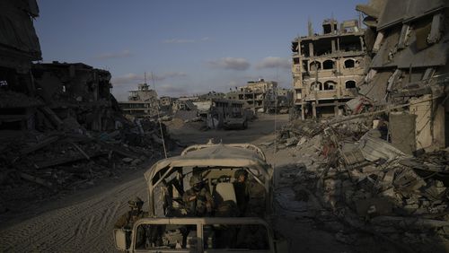 FILE - Hezbollah fighters carry one of the coffins of four fallen comrades who were killed Tuesday after their handheld pagers exploded, in the southern suburb of Beirut, Wednesday, Sept. 18, 2024. (AP Photo/Bilal Hussein, File)