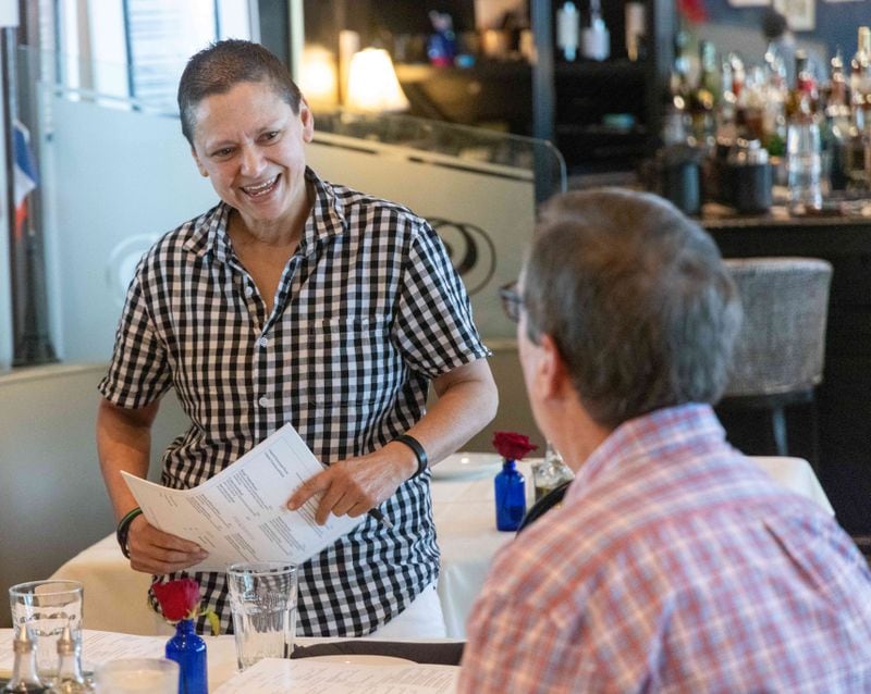 Kelly Youssef (right) talks with a diner at La Petite Maison restaurant in Sandy Springs. PHIL SKINNER FOR THE ATLANTA JOURNAL-CONSTITUTION