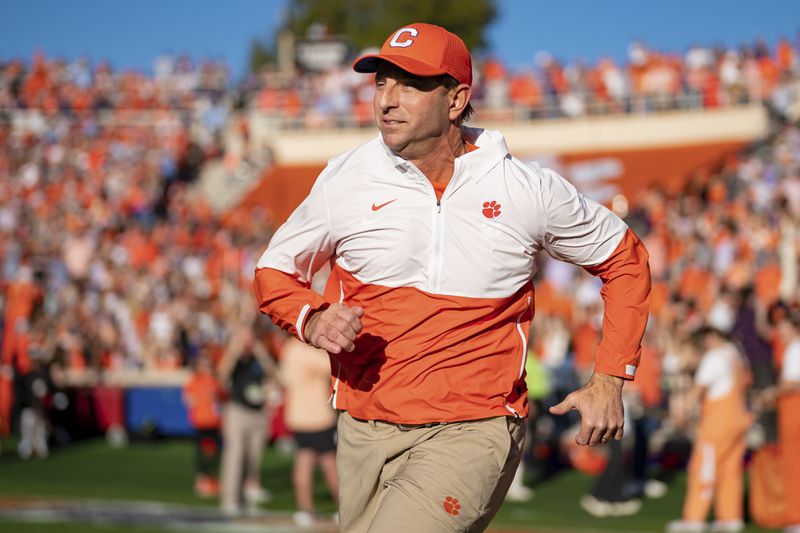 Clemson head coach Dabo Swinney runs onto the field before an NCAA college football game against North Carolina Saturday, Nov. 18, 2023, in Clemson, S.C. (AP Photo/Jacob Kupferman)