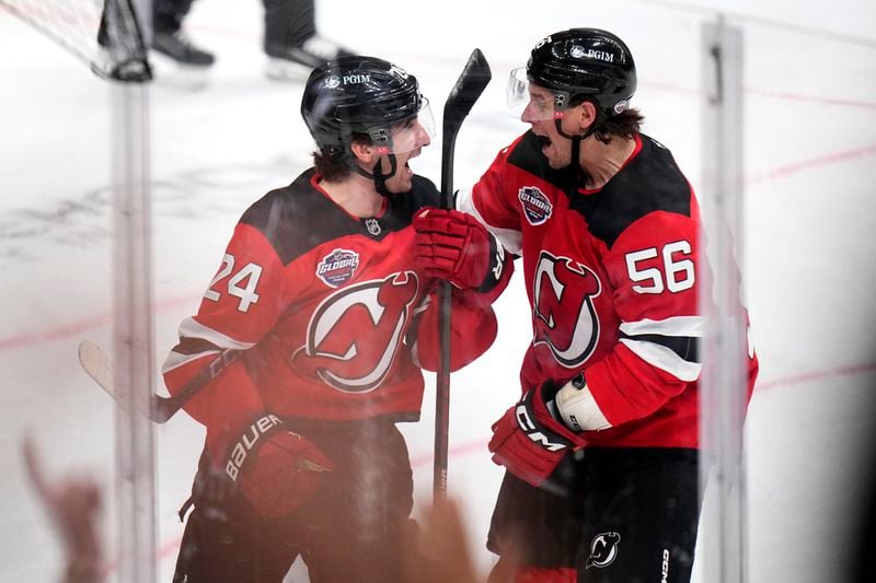 New Jersey Devils' Seamus Casey, left, celebrates with New Jersey Devils' Erik Haula after scoring his sides first goal during the NHL hockey game between Buffalo Sabres and New Jersey Devils, in Prague, Czech Republic, Saturday, Oct. 5, 2024. (AP Photo/Petr David Josek)