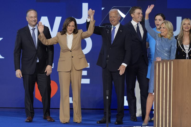 Democratic presidential nominee Vice President Kamala Harris and President Joe Biden on stage with second gentleman Doug Emhoff, left, and first lady Jill Biden, right, during the Democratic National Convention Monday, Aug. 19, 2024, in Chicago. (AP Photo/J. Scott Applewhite)