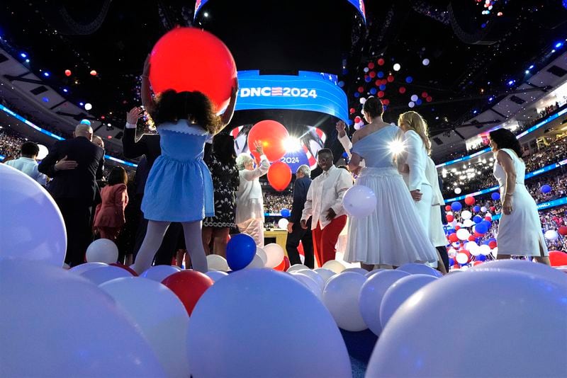 Democratic presidential nominee Vice President Kamala Harris, second gentleman Doug Emhoff, Democratic vice presidential candidate Minnesota Gov. Tim Walz and his wife Gwen Walz and members of their families stand on stage as balloons drop on the final night of the Democratic National Convention in Chicago, Thursday, Aug. 22, 2024. (Kent Nishimura/The New York Times via AP, Pool)