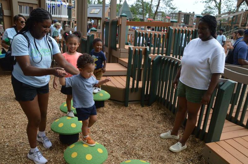 Families play in one of the areas at the new PlayTown Suwanee playground. (Photo Courtesy of Curt Yeomans)