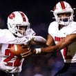 North Gwinnett quarterback Ethan Washington (2) hands the ball off to running back Brinston Williams (22) during Friday's game against Parkview in Lilburn. North Gwinnett prevailed 34-27. Casey Sykes/Special to the AJC