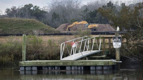 A dock with a fish consumption advisory sign is shown near the Terry Creek Dredge Spoil Areas/Hercules Outfall Superfund site in Brunswick. The site is one of four Superfund sites located around Brunswick, and active clean-up work is ongoing. (AJC Photo/Stephen B. Morton)