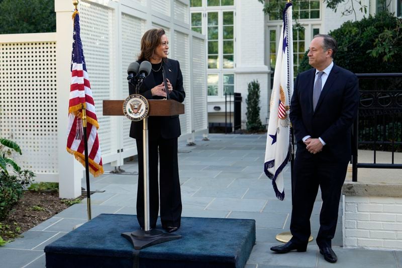 Democratic presidential nominee Vice President Kamala Harris speaks as second gentleman Doug Emhoff looks on before planting a memorial tree on the grounds of the Vice President's residence in Washington on Monday, Oct. 7, 2024, to honor the victims and mark one year since the Oct. 7, 2023, Hamas attack on Israel. (AP Photo/Ben Curtis)