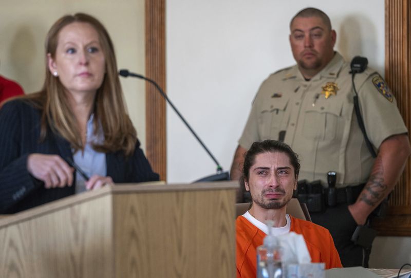 FILE - Ryan Martinez, seated, cries during his preliminary and detention hearing in Tierra Amarilla, N.M., Friday, Oct. 13, 2023, as his attorney Nicole Moss, describes the events that led to him allegedly shooting Jacob Johns during a rally outside the Rio Arriba County Complex in Espanola. (Eddie Moore/The Albuquerque Journal via AP, File)