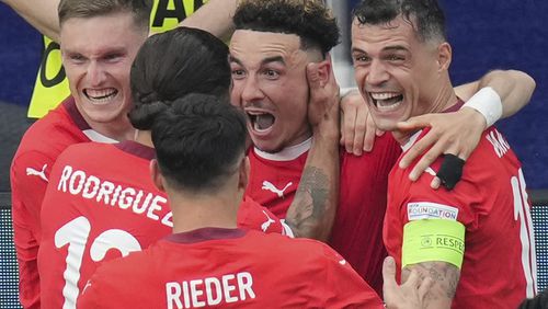 Switzerland's Ruben Vargas, center, celebrates with teammates after scoring his side's second goal during a round of sixteen match between Switzerland and Italy at the Euro 2024 soccer tournament in Berlin, Germany, Saturday, June 29, 2024. (Soeren Stache/dpa via AP)