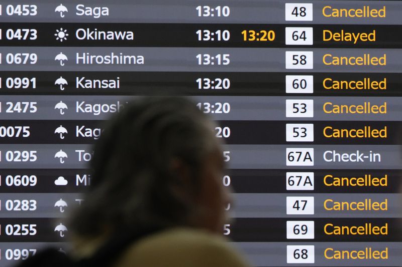 A notice board of departure flights is seen as many flights were canceled as a severe weather system is affecting Japan, at Haneda airport Friday, Aug. 30, 2024, in Tokyo. (AP Photo/Eugene Hoshiko)