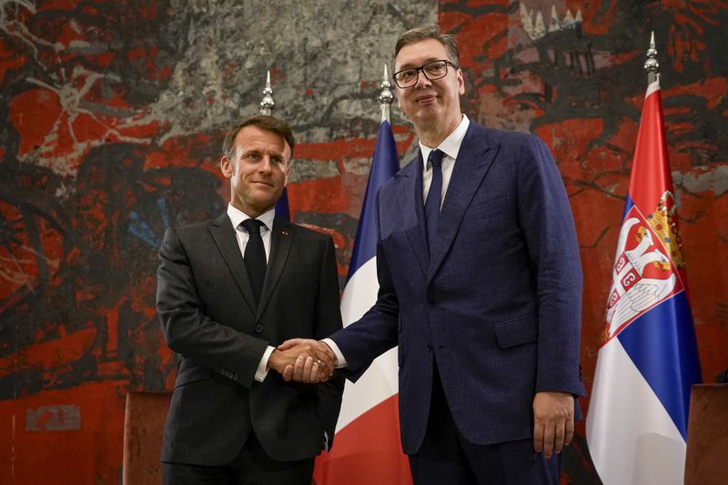 French President Emmanuel Macron, left, shakes hands with Serbian President Aleksandar Vucic in Belgrade, Serbia, Thursday, Aug. 29, 2024. French President Emmanuel Macron starts a two-day state visit to Serbia with the focus on a possible sale of 12 Rafale multi-purpose fighter jets to a country that has maintained close ties to Russia despite its aggression on Ukraine. (AP Photo/Darko Vojinovic)