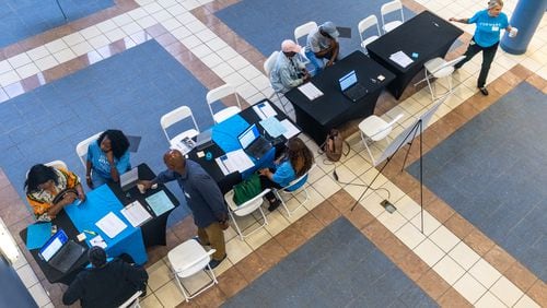 Volunteers help participants during the application assistance session at Atlanta Metro State College on Tuesday, Aug 6, 2024, apply for the anti-displacement tax relief fund program. (Steve Schaefer / AJC) 