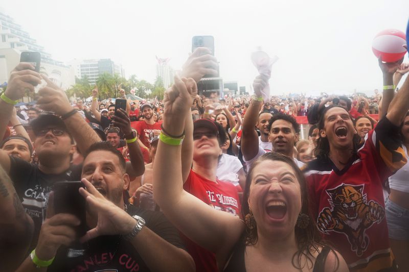 Fans cheer the Florida Panthers team during an NHL hockey parade and rally to celebrate the team's winning of the Stanley Cup by defeating the Edmonton Oilers, Sunday, June 30, 2024, in Fort Lauderdale, Fla. (AP Photo/Marta Lavandier)