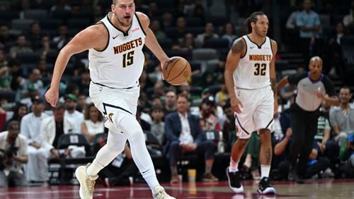 Denver Nuggets Nikola Jokic in action during a preseason game between Boston Celtics and Denver Nuggets in Abu Dhabi, United Arab Emirates, Friday, Oct. 4, 2024. (AP Photo/Martin Dokoupil)