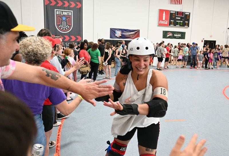 Samantha Flowers, a.k.a ThumpHER, celebrates with fans after Atlanta Roller Derby game at Agnes Scott College’s Woodruff Athletic Complex, Saturday, June 8, 2024, in Decatur. (Hyosub Shin / AJC)