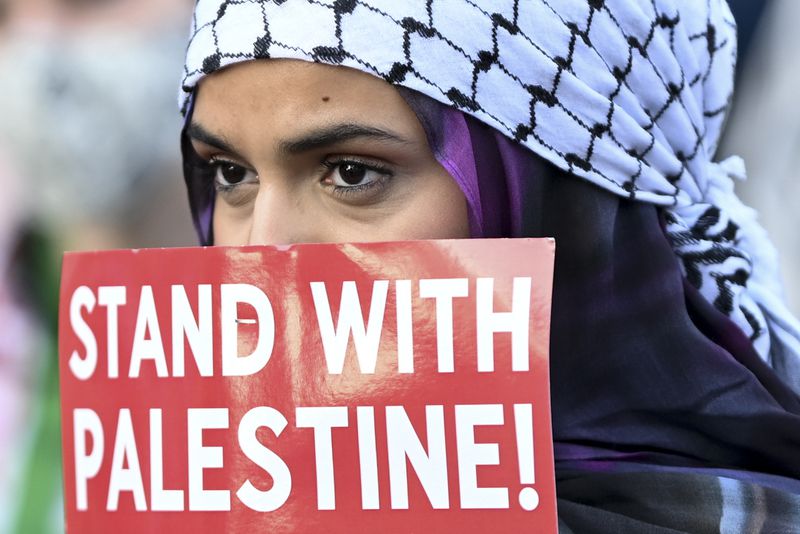 A protester listens during a demonstration near the Democratic National Convention Thursday, Aug. 22, 2024, in Chicago. (AP Photo/Noah Berger)