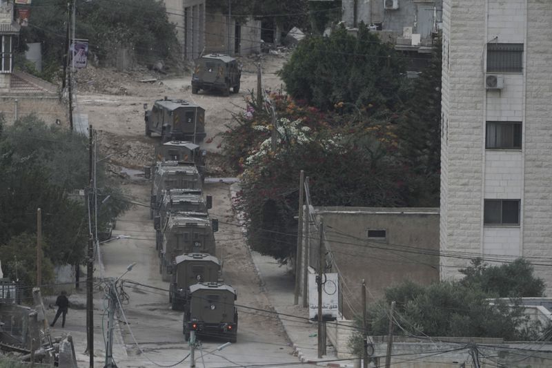 Israeli armoured vehicles move during a military operation in the West Bank Jenin refugee camp, Saturday, Aug. 31, 2024. (AP Photo/Majdi Mohammed)