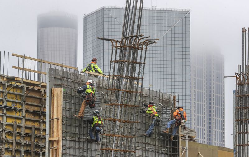 Overall, metro Atlanta added 72,000 jobs last year. The construction sector, which has about 146,000 workers, grew by 4,700. Here, workers on an 18-story, 304-unit apartment tower being built across from Mercedes-Benz Stadium near downtown. (John Spink / John.Spink@ajc.com)