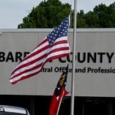 The American and Georgia flags outside Barrow County School System’s central office fly at half-staff a day after two students and two teachers were gunned down, Thursday, September 6, 2024, in Winder. A 14-year-old opened fire at a Barrow County high school Wednesday morning, killing two students and two teachers and injuring nine others, according to investigators. The shooting at Apalachee High School shocked not only the local community nestled between Atlanta and Athens, but soon made national headlines throughout the day, with federal and state law enforcement agencies assisting with the investigation. (Hyosub Shin / AJC)