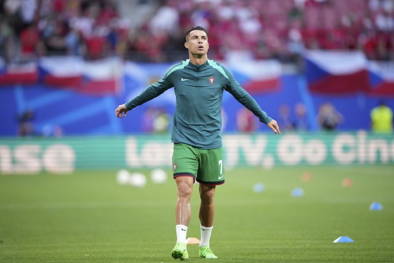 Portugal's Cristiano Ronaldo warms up prior to a Group F match between Portugal and Czech Republic at the Euro 2024 soccer tournament in Leipzig, Germany, Tuesday, June 18, 2024. (AP Photo/Ebrahim Noroozi)