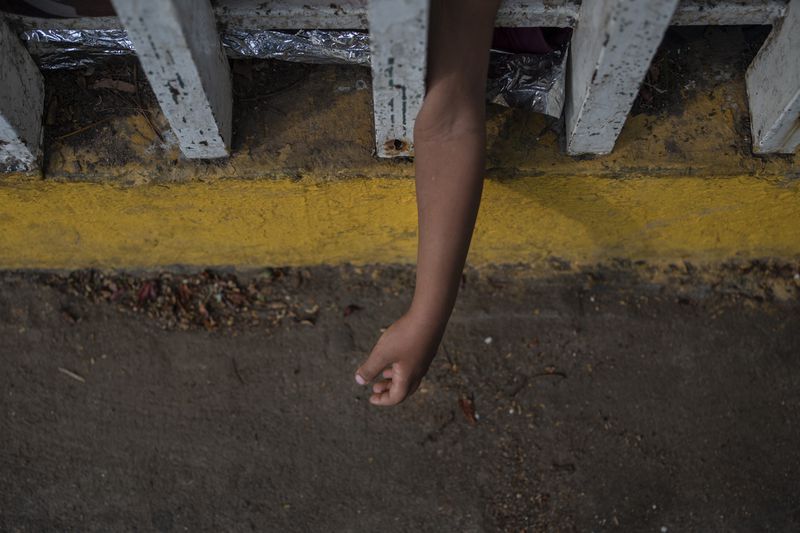 The Bolaños sisters, from Venezuela, sleep on the ground outside the bus terminal where they are living with their single mother Keilly and one other sibling, along with other migrants in Villahermosa, Mexico, Saturday, June 8, 2024. Their mother said that in Mexico's northern state of Juarez she was beaten by the military in front of her children, loaded on a bus for two days, and left in Villahermosa. (AP Photo/Felix Marquez)