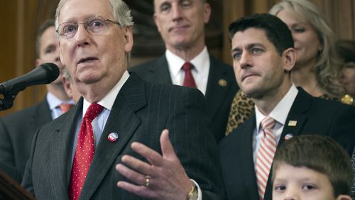 House Speaker Paul Ryan of Wis., and others, listen as Senate Majority Leader Mitch McConnell of Ky., speaks on Capitol Hill last month. (AP Photo/Cliff Owen, File)