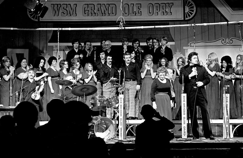 FILE - Country music stars, including Johnny Cash, foreground right, and Maybelle Carter, next to Cash, perform during the Grand Ole Opry's last show at Ryman Auditorium in Nashville, Tenn., March 18, 1974. (AP Photo/John Duricka)