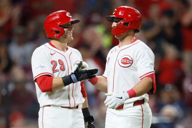 Cincinnati Reds' Spencer Steer, right, celebrates his home run against the Atlanta Braves with teammate TJ Friedl during the seventh inning of a baseball gam,e Tuesday, Sept. 17, 2024, in Cincinnati. (AP Photo/Jay LaPrete)