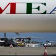 A Greek military transport aircraft carrying Greek and Cypriot citizens evacuated from Lebanon, is seen behind an MEA airlines, after it landed at Larnaca airport, Cyprus, on Thursday, Oct. 3, 2024. (AP Photo/Petros Karadjias)