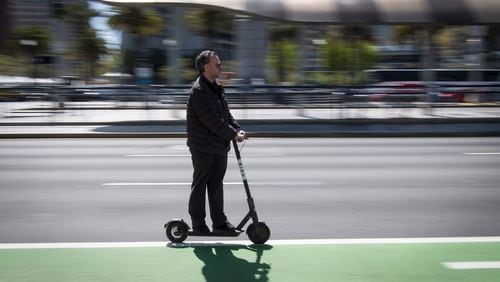 A person rides a Bird Rides shared electric scooter on the Embarcadero in San Francisco, California, on April 13, 2018. MUST CREDIT: Bloomberg photo by David Paul Morris Photo by: David Paul Morris - Bloomberg