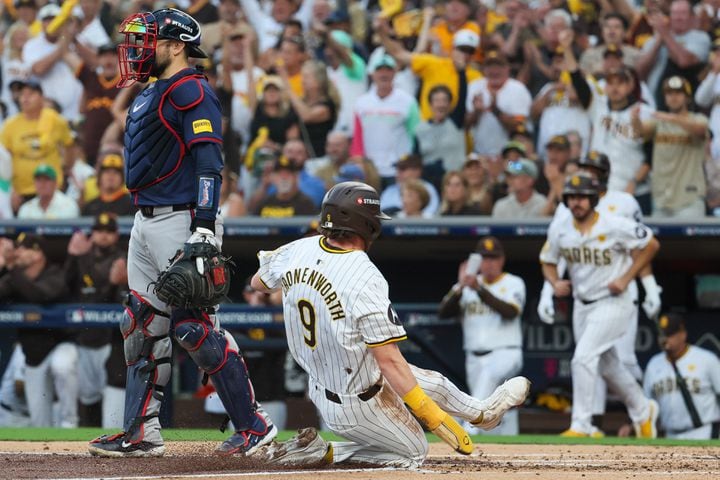 San Diego Padres’ Jake Cronenworth (9) scores against the Atlanta Braves on a sacrifice fly by Kyle Higashioka during the second inning of National League Division Series Wild Card Game One at Petco Park in San Diego on Tuesday, Oct. 1, 2024.   (Jason Getz / Jason.Getz@ajc.com)